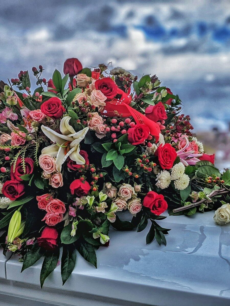 a bunch of flowers sitting on top of a car